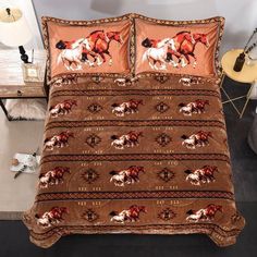 a bed with horses on it in a room next to a night stand and lamp