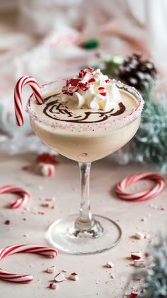 a drink with whipped cream and candy canes