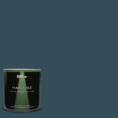 a can of behr marquee paint on a green background