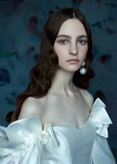 a painting of a woman wearing a white dress and pearl earrings, in front of a blue background