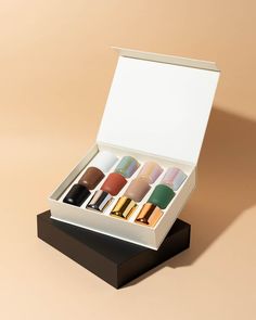 an open box with different colored lipsticks in it