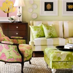 a living room filled with furniture next to a wall mounted art piece on the wall