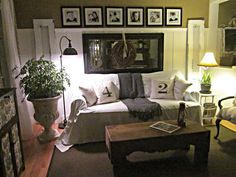 a living room filled with furniture and pictures on the wall