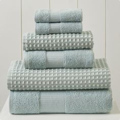 a stack of towels sitting on top of a white table