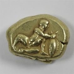 a gold brooch depicting a man riding a horse