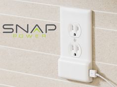 a white wall outlet with the snap power logo on it