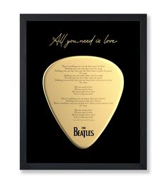 the beatles all you need is love guitar picker in black frame with gold lettering