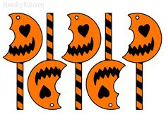 four halloween candy lollipops with jack - o'- lanterns on them