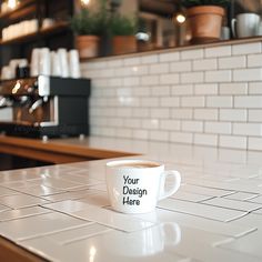 a white coffee cup sitting on top of a counter