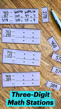 two rows of numbered numbers on a wooden table with a pen and ruler next to them