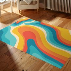 a colorful area rug in the middle of a living room with a chair and radiator