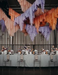 the table is set up with paper streamers hanging from the ceiling