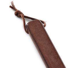 an old wooden case with a string tied around the end on a white background,