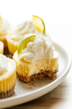 small cupcakes with frosting and lime slices on a plate