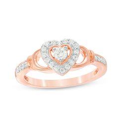 Mimicking the Claddagh style, this charming diamond promise ring pledges your commitment. Crafted in precious 10K rose gold, this meaningful design features a sparkling 1/10 ct. diamond center stone in a heart-shaped diamond-lined halo frame. Along the open shank, cupped collars and diamond ribbons complete this shimmering choice. Radiant with 1/4 ct. t.w. of diamonds and a bright polished shine, this promise ring shares your love. Rose Gold Promise Ring, Diamond Ribbon, Diamond Promise Ring, Disney Fine Jewelry, Meaningful Design, Diamond Promise Rings, Peoples Jewellers, Heart Frame, Heart Shaped Diamond