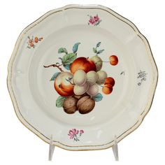 a plate with apples and nuts painted on it