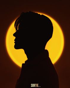 the silhouette of a person in front of a yellow circle with words that read sortie