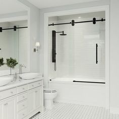 a white bathroom with two sinks and a large mirror above the bathtub is shown