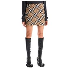 This Burberry mini kilt skirt is made of a wool blend fabric with the iconic Burberry Check pattern all over in color Linden. The back features pleats and it has a wrap design with an EKD button and an adjustable B buckle strap on the side. It is finished with raw cut fringed edges and has a trapeze silhouette. The model is 5'8 tall and wears a UK size 6. Trapeze Silhouette, Kilt Skirt, Makeup Travel Case, Plastic Pollution, Travel Makeup, Kilt, Beauty Accessories, Check Pattern, Accessories Design