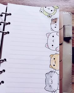 an open notebook with drawings of cats and dogs lined up on top of each other