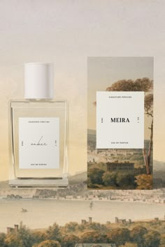 a bottle of perfume sitting on top of a table next to a box with the name mera