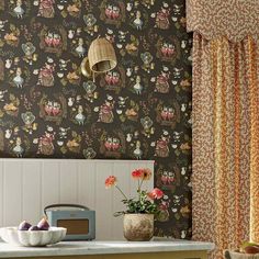 an image of a kitchen setting with wallpaper and flowers on the counter top in front of it