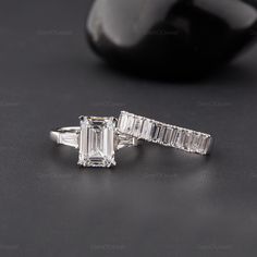 an emerald cut diamond ring with baguettes on the side