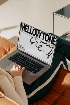 a woman sitting on a couch using a laptop with the word mellowtone written on it