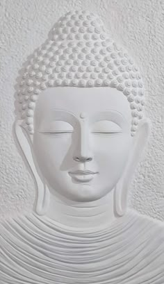 a white buddha statue sitting on top of a table