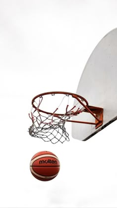 a basketball flying through the air next to a net with a ball on it's side