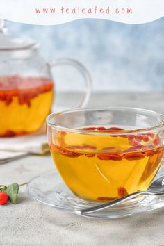 two glasses filled with dessert sitting on top of a table