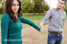 a man and woman holding hands in the park