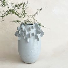 a blue vase with some plants in it