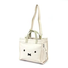 This Miffy stylish tote bag is the perfect accessory for everyday use. The Miffy Face design is bright and eye-catching, and it features a removable shoulder strap and inner pockets for securely carrying all your essentials. Its magnetic closure ensures the bag stays securely closed. DESCRIPTIONS - Color: Cream - Cotton- Size: approx. 11.02"w x 9.45"h x 5.51"d (excluding handle) Miffy Bag, Miffy Backpack, Miffy Merch, Miffy Tote Bag, Miffy Accessories, Miffy Products, Miffy Coin Pouch, Convertible Tote Bag, Stylish Tote Bag