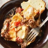 a brown plate topped with lasagna and bread