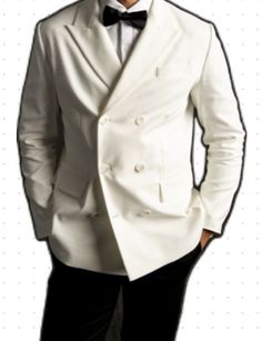 a man in a white tuxedo is posing for the camera with his hands on his hips