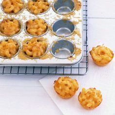 several muffin tins on a cooling rack next to some cupcake batter in them