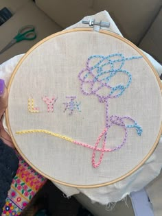 someone is holding up a hand embroidery project