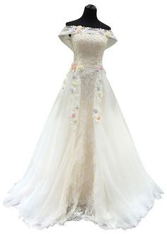 a white wedding dress with flowers on it