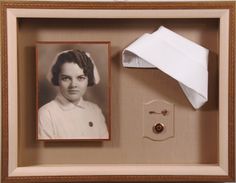 an old photo is in a shadow box with paper on the side and a pair of scissors next to it