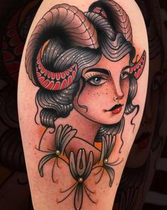 a woman with long hair and horns on her head is depicted in this tattoo design