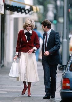 a man and woman walking down the street