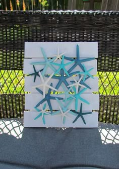 some blue and white starfishs are on a piece of paper in front of a wicker basket