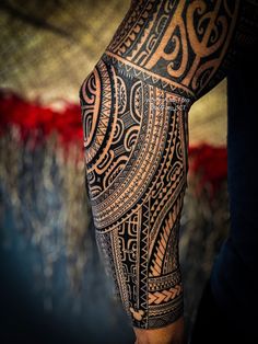 a man's leg with an intricate tattoo on it