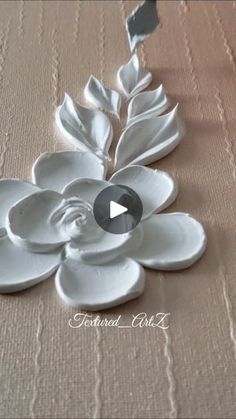 a white flower sitting on top of a table