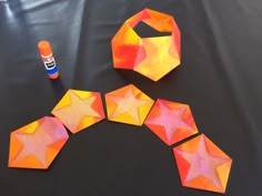 the paper stars are cut out and placed on the table next to each other with glue