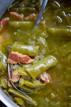 a spoon full of green beans and bacon soup