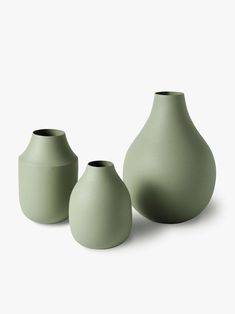 three green vases sitting next to each other