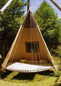 an image of a bed made out of a hammock hanging from a pole