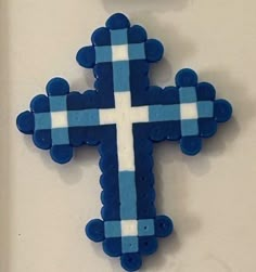 a blue and white cross hanging on the wall